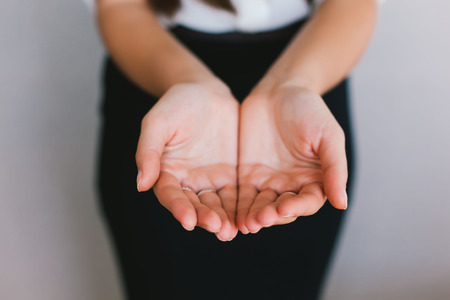 close up of womans cupped hands showing somethingの写真素材