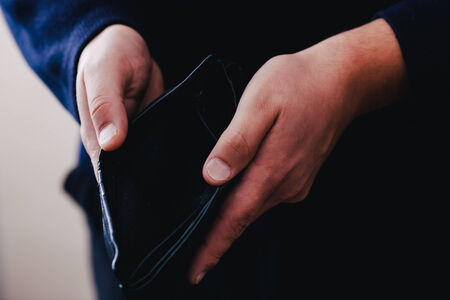 Hands hold an empty purse