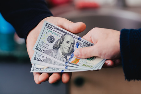 Give money from hand to handの写真素材