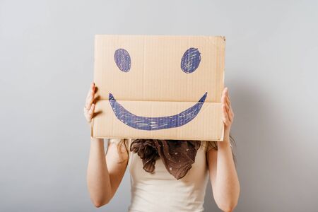 Young woman with a smiley On a gray background.の写真素材