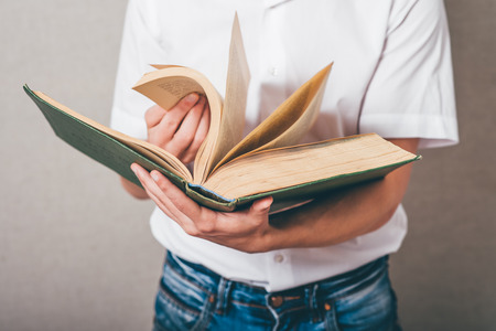 man in glasses reading a big bookの写真素材