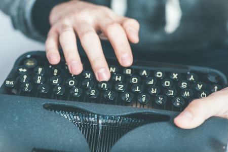 handsome journalist writing with typewriterの写真素材