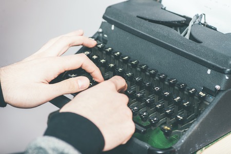 handsome journalist writing with typewriterの写真素材