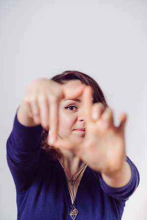 woman making a hand frame