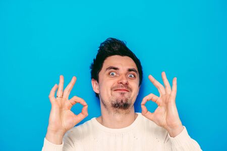 man shows that everything is fine, do not worry. all okay. Gesture. Close portrait.