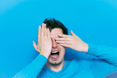 Man closes eyes with her handsの写真素材