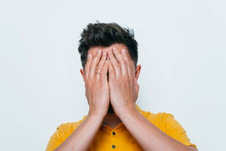 man covered his face with his hands