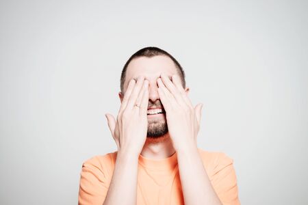 Man closes eyes with her handsの写真素材