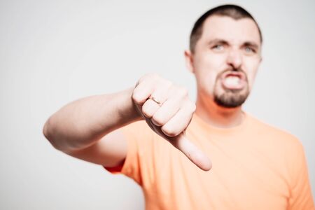 man showing a thumb down gestureの写真素材