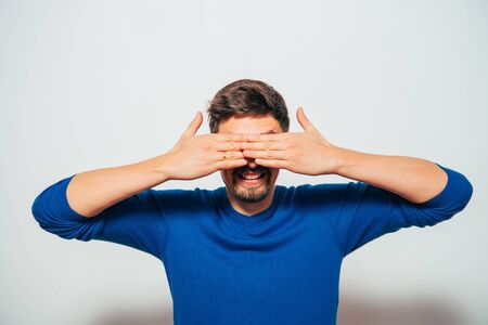 Man closes eyes with her handsの写真素材