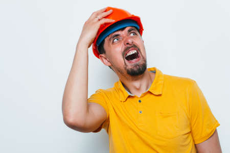 man close-up in helmet , holding his head by hand