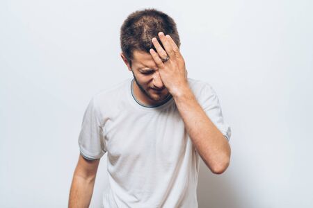 man covers his face by handの写真素材