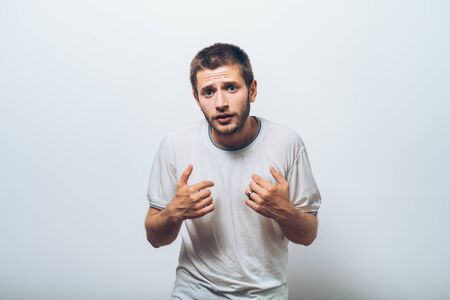 Male hand forefinger pointing to himself on the chest. Gesture. who am i. On a gray backgroundの写真素材