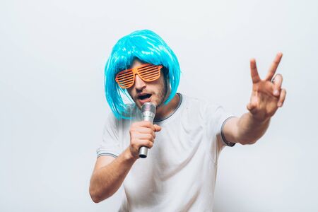crazy funny young man with blue wigの写真素材