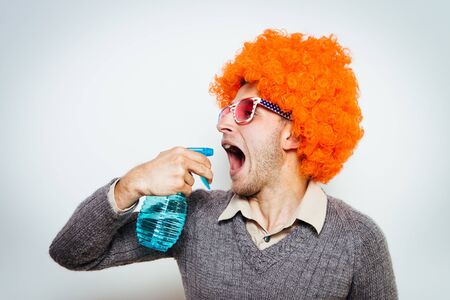 guy in a wig with a cleaner for windowsの写真素材