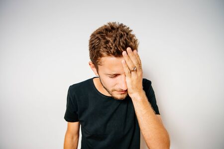 man covers his face by handの写真素材