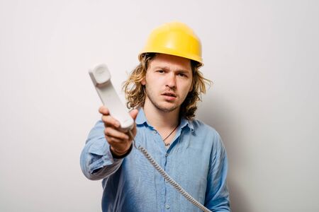 Young contractor on the phone in the office. Construction