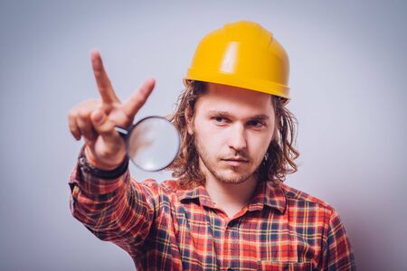 builder with magnifying glass