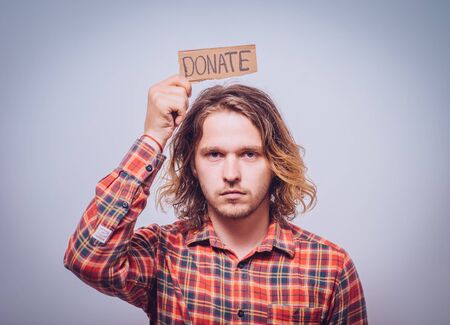 male, cardboard sign donation. On a gray background