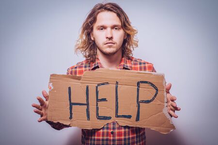 cardboard with text donate help. On a gray background.
