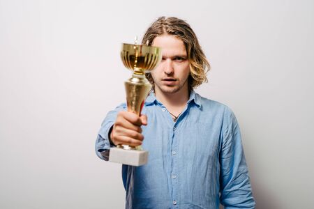 man holding a trophyの写真素材