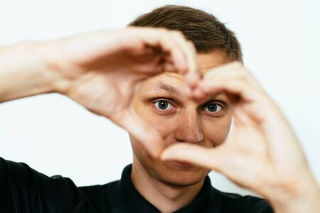 man making a hand heart frameの写真素材