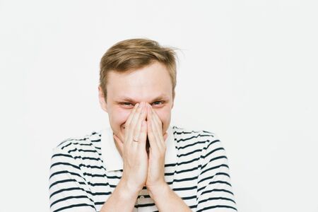 man laughs and covers her mouth
