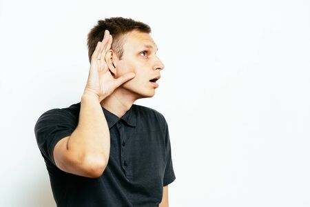Overhears a man, tries to listen.の写真素材