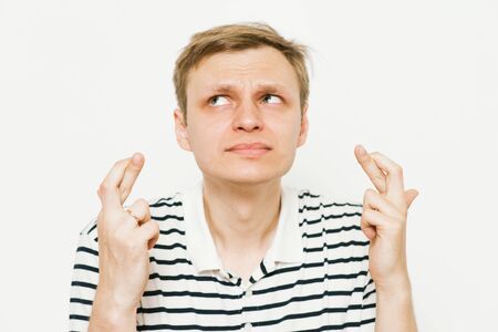 man crosses his fingers. Good luck, hope