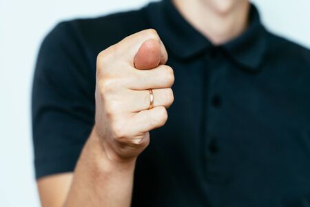 man shows a fig at the