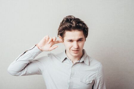 young man closes his ear