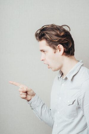 Portrait of a smart guy pointing to somethingの写真素材