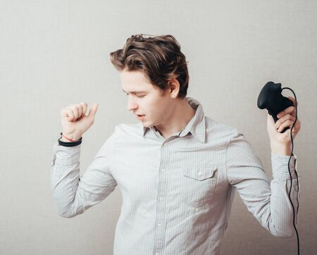 young man with a joystickの写真素材