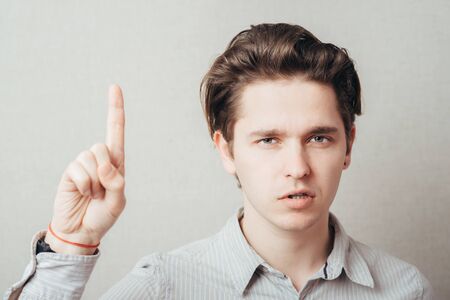 man pointing up with his index fingerの写真素材