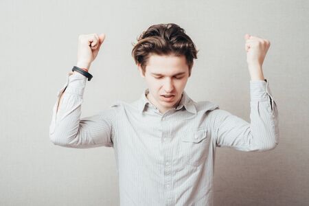 handsome excited man happy smile, raised hands arms palms, young guy casual wear, full lengthの写真素材