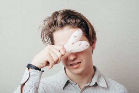 Man holding a heart in his handsの写真素材