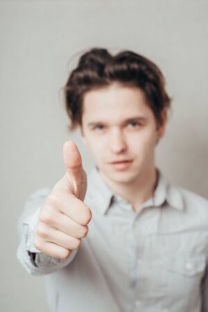 young man showing thumb up
