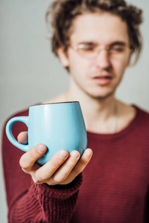 Man holding a cup of coffee の写真素材
