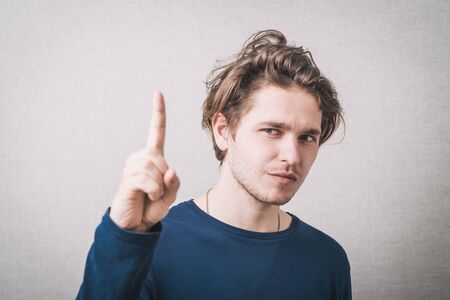 man shows the index finger up