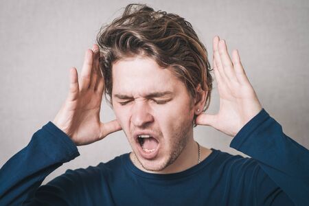man yelling and took his headの写真素材