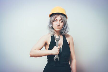 girl in a yellow helmet with a key