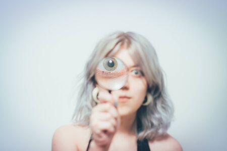 Woman with magnifying glassの写真素材