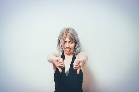 Woman showing a thumb down gestureの写真素材