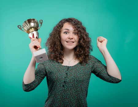 Woman with a golden cupの写真素材