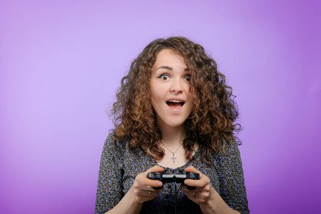 Woman playing on the joystick in a game console