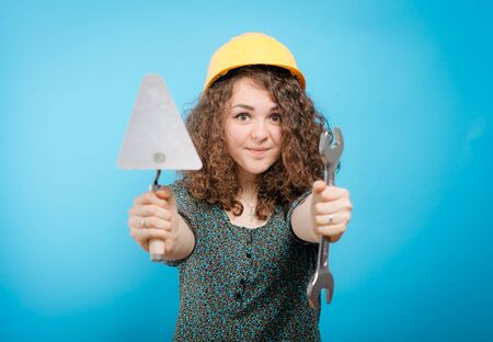 girl in a yellow helmet with a keyの写真素材