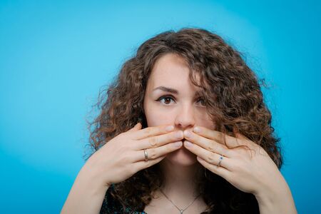 Girl laughs and covers her mouth
