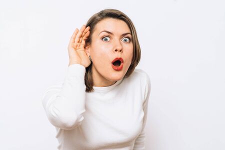 Overhears a woman, tries to listen.