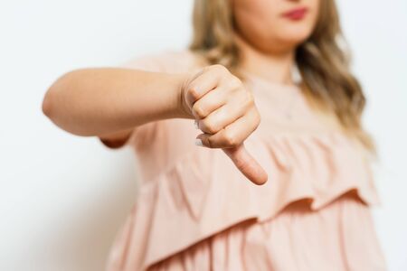 Woman showing a thumb down gesture