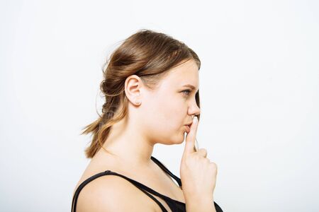 woman put finger on her lipsの写真素材